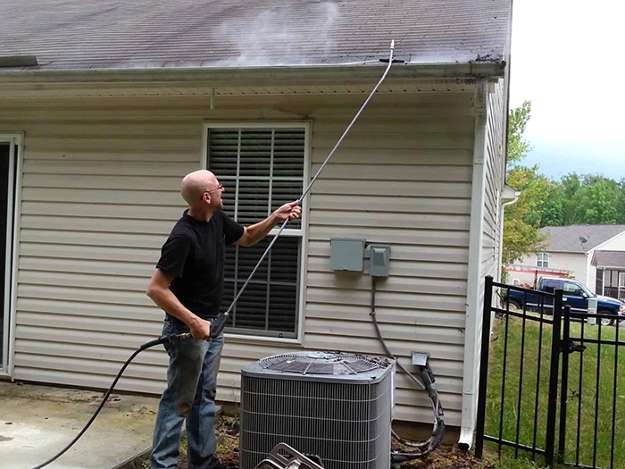 Local Gutter Cleaning Services in Puyallup​ Man clearing roof gutters